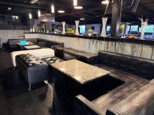 Black lounge seating and marble tables inside Nations Rhythm