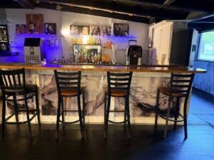 Nations Rhythm bar with blue lighting, marble panels and black bar stools